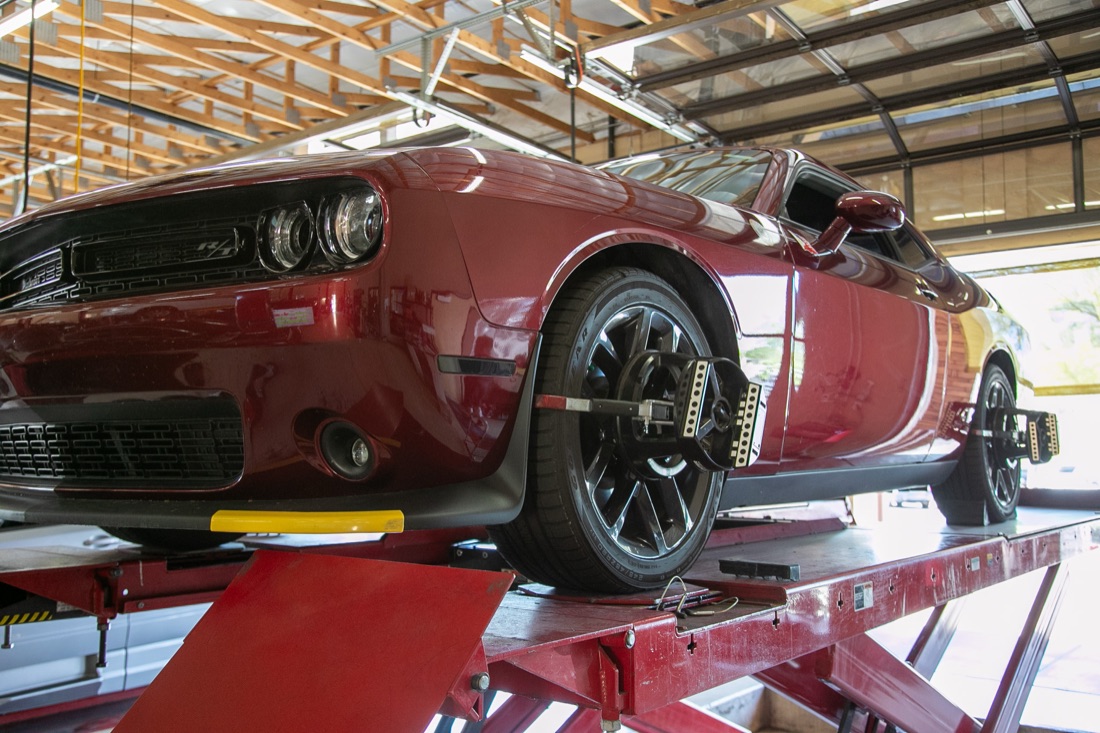 Red Dodge Challenger on a lift