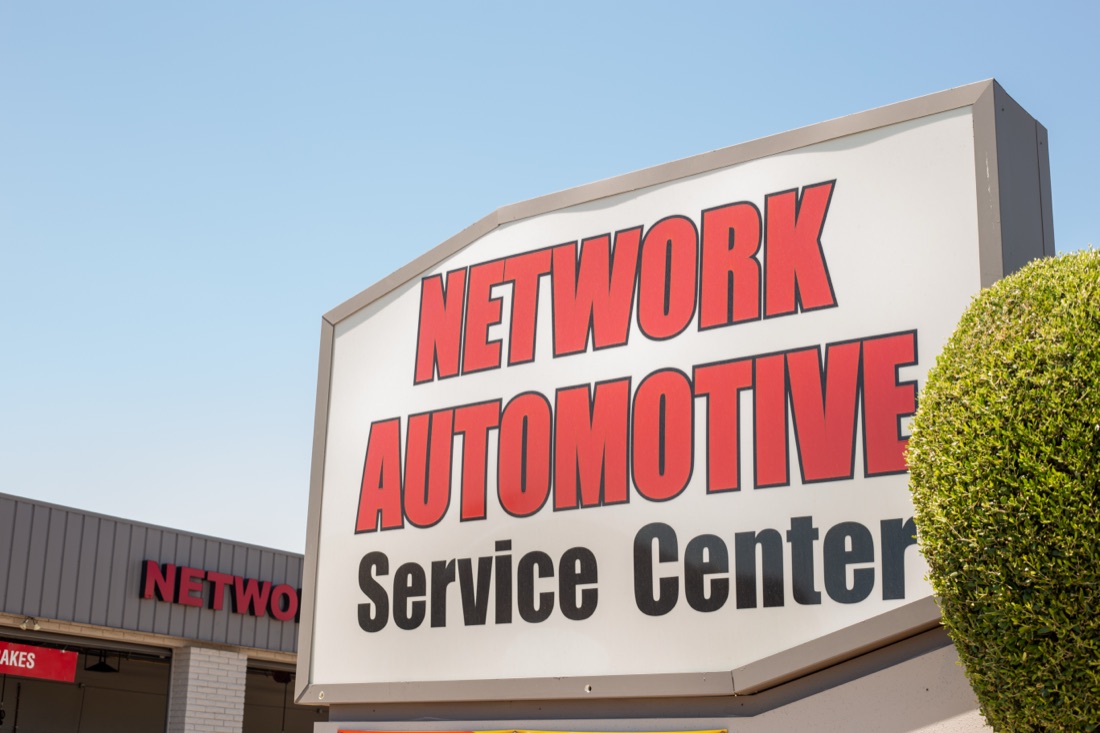Network Automotive Service Center sign against a blue sky