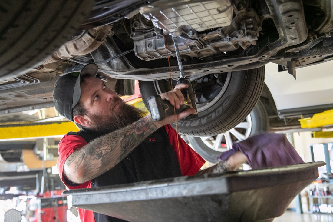 Technician working underneath a vehicle