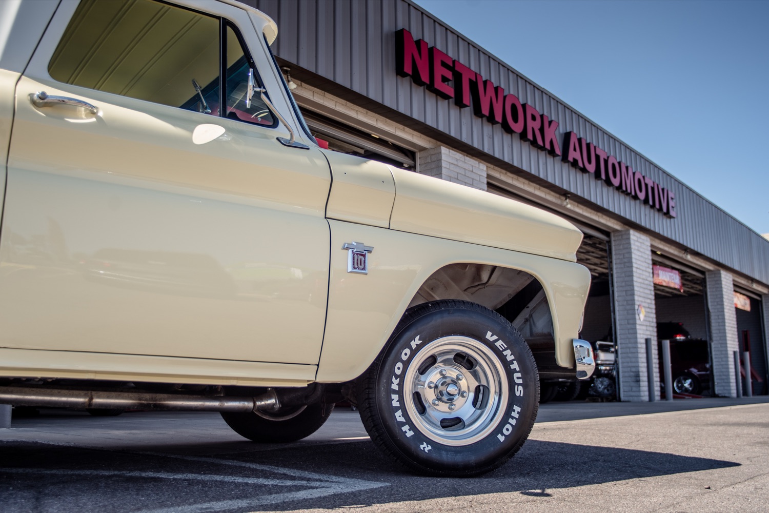 Classic pickup parked in front of a Network Automotive Service Center